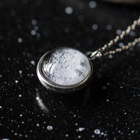 Two-sided full moon necklace with glass dome showing near and far side of the moon
