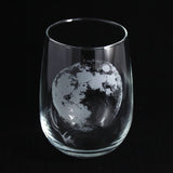 An etched stemless wine glass with a realistic full moon, space themed
