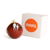 Planet Mars Christmas ornament with adult and child astronaut holding hands. Space-themed ornament with box