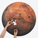 A round Mars Puzzle mostly finished, showing pieces and hands