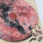 A uniqe round Mars puzzle made from wood, with oddly shaped pieces including special pieces an alien, Curiosity Rover, a spaceship and more! A round space-themed planet puzzle gift.