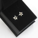 Space earrings in sterling silver with star shape and campo del cielo meteorite in center. Shown in gift box.