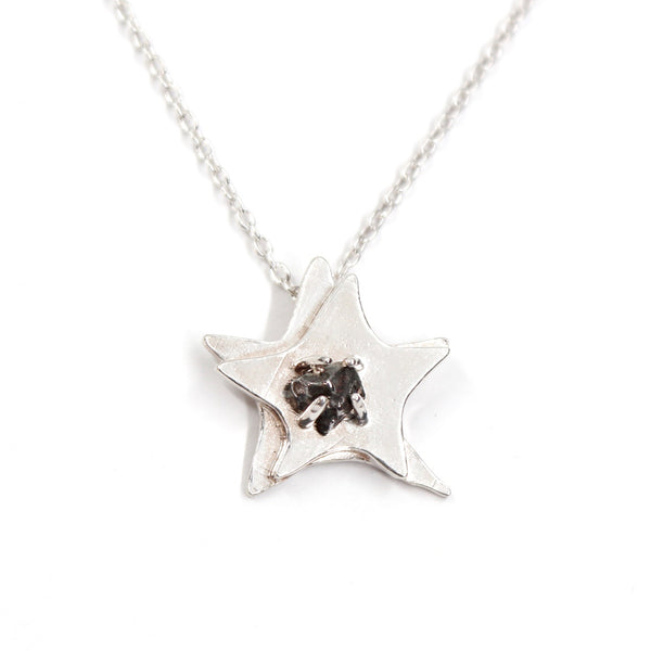 A space-themed necklace! Dual layered solid sterling silver star with a Campo del Cielo meteorite in the center.