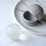 A silicone moon ice mold to make moon shaped ball ice cubes.