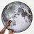 moon surface puzzle from Parkside Puzzles (formerly Four Point Puzzles) with 1000 pc round design. A space gift for space enthusiasts! Shows someone building the puzzle.