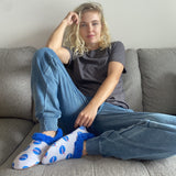 Woman wearing NASA space-themed astronaut slippers space gift.
