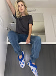 Woman wearing NASA space-themed astronaut slippers