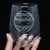 Hand holding an etched stemless wine glass with the planet Jupiter, space themed