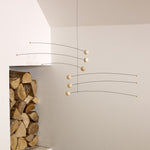Futura mobile by danish Flensted Mobiles. Looks like moons and planets in space. Natural wood.