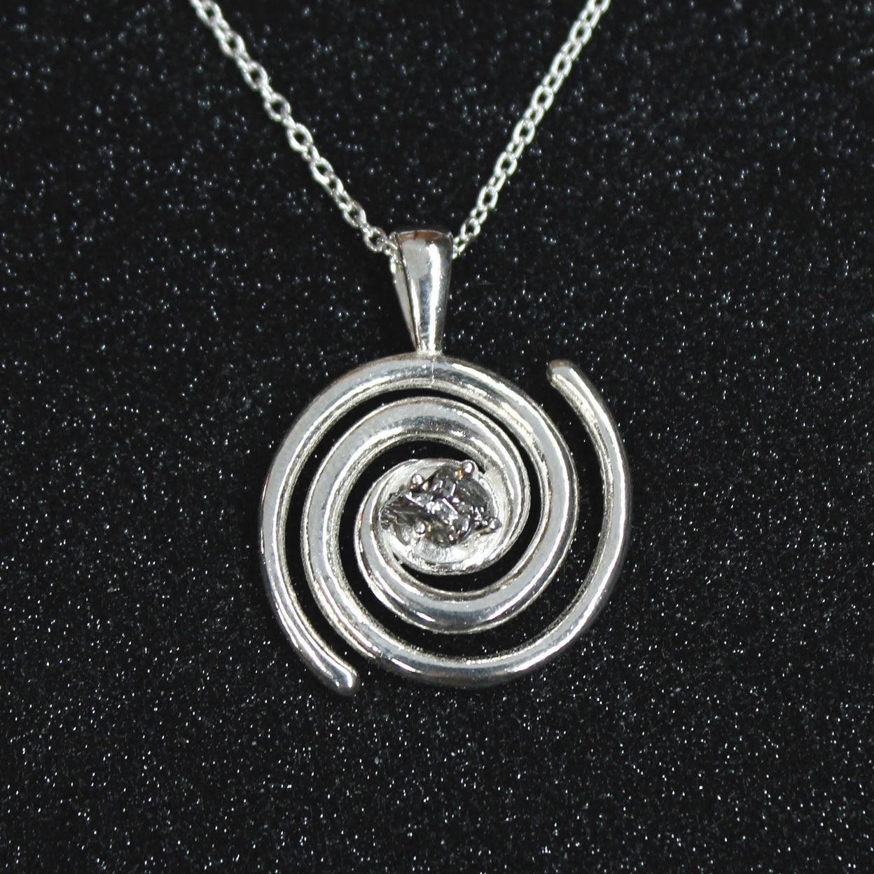 Spiral galaxy necklace with a genuine Campo del Celio meteorite in the center! A solid sterling silver spiral galaxy necklace is the perfect space gift.