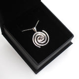 Spiral galaxy necklace with a real Campo del Celio meteorite in the center! A solid sterling silver spiral galaxy necklace is the perfect space gift.