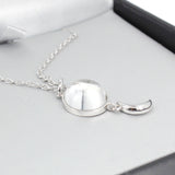side view of swaying crescent moon meteorite necklace in sterling silver