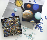 The Planets Puzzle - Open box showing space puzzle pieces and poster