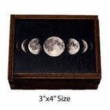 Small wooden trinket box with moon phases on sliding lid.