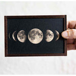 Wooden trinket box with moon phases on sliding lid.