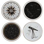 A set of four porcelain, white, black and gold astronomy/space-themed drink coasters showing stars, constellations, a telescope, and a compass rose.
